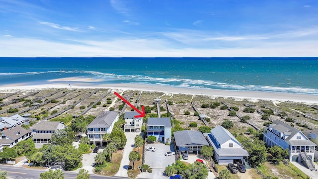 drone / aerial view with a beach view, a water view, and a residential view