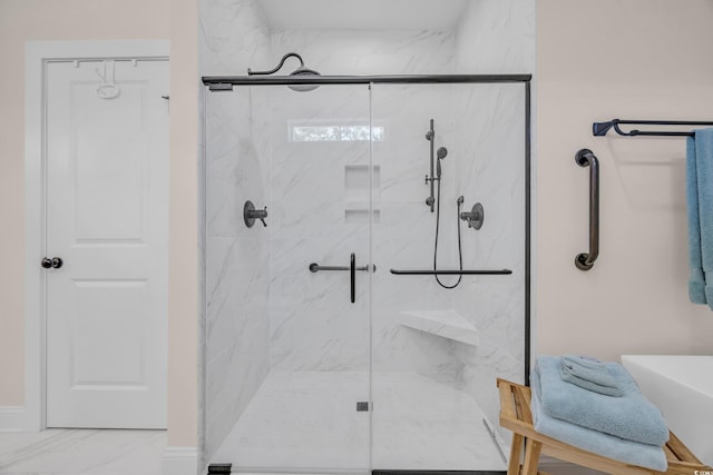 full bath with a marble finish shower and marble finish floor