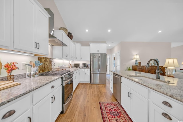 kitchen with white cabinetry, stainless steel appliances, and a sink
