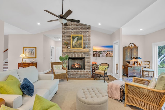 living room featuring ceiling fan, lofted ceiling, a brick fireplace, and recessed lighting