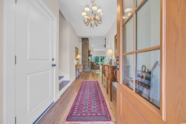 corridor featuring a notable chandelier and wood finished floors