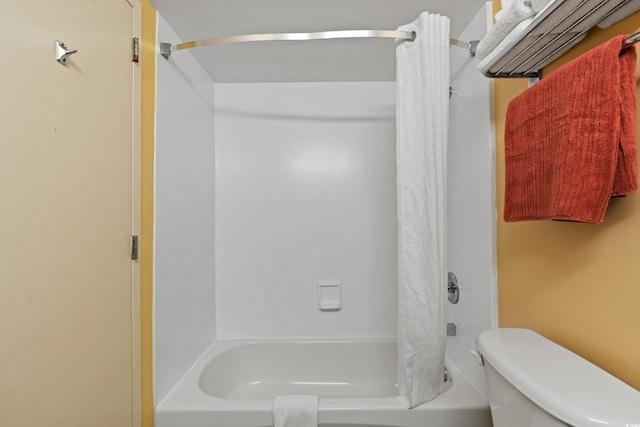 bathroom featuring toilet and shower / bath combination with curtain