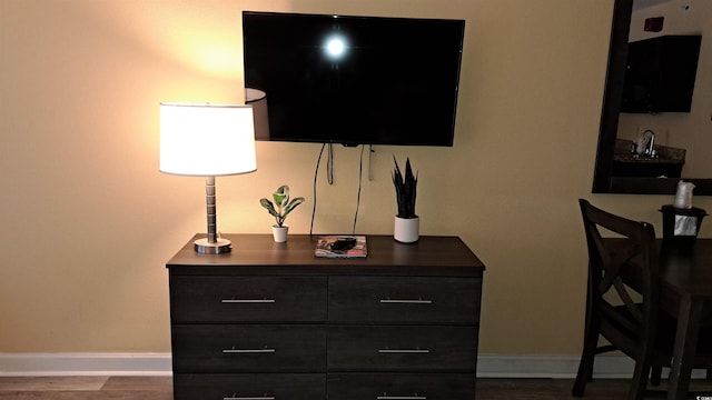 interior space featuring baseboards and wood finished floors