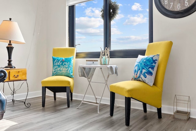 sitting room with wood finished floors and baseboards