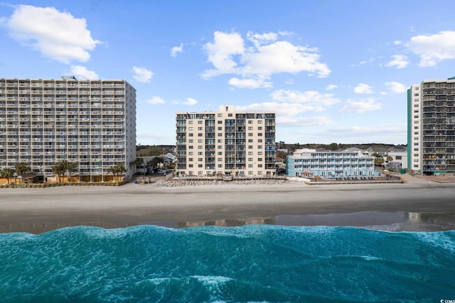 aerial view of waterfront with a beach and apartment complex / building