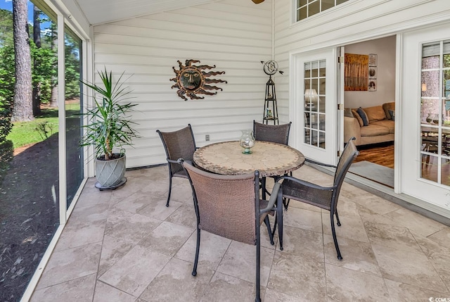 sunroom featuring outdoor dining area