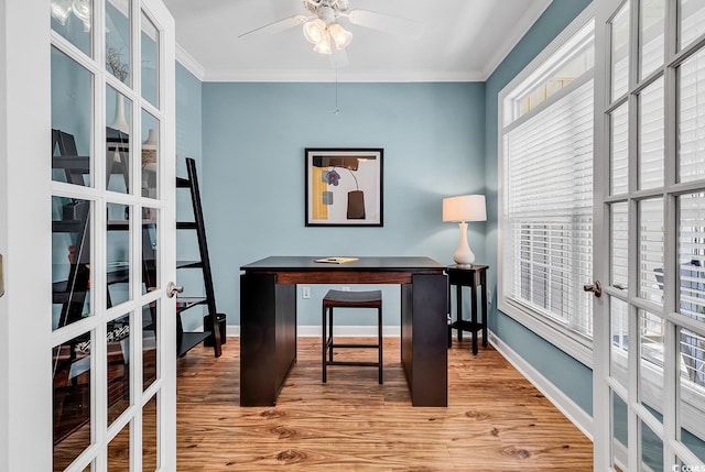 office with crown molding, wood finished floors, baseboards, ceiling fan, and french doors