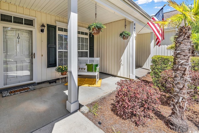 property entrance featuring a porch and board and batten siding