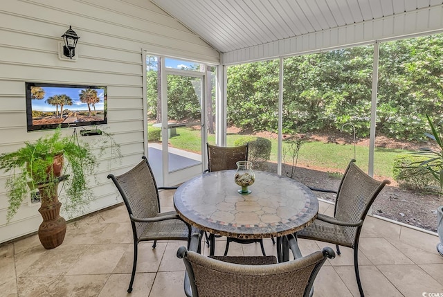 sunroom with outdoor dining area