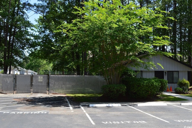 uncovered parking lot with a gate and fence