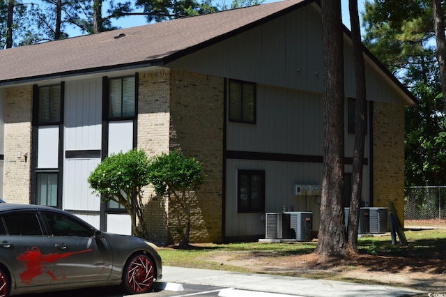 view of property featuring central AC and fence