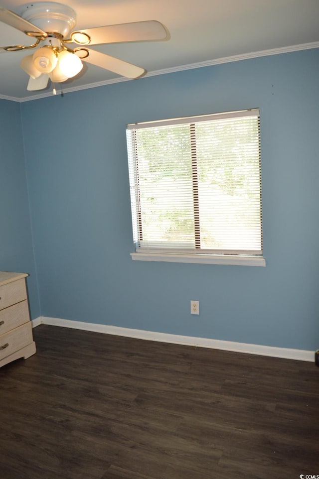 empty room with baseboards, dark wood-style flooring, crown molding, and a ceiling fan