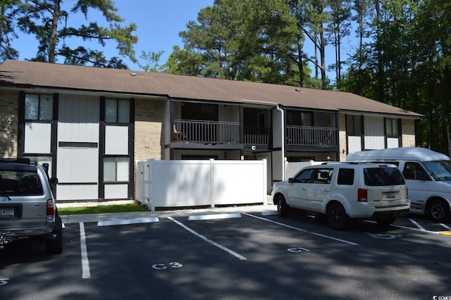 950 Forestbrook Rd Unit C3, Myrtle Beach, SC 29579 - view of front facade featuring uncovered parking, a shingled roof, and brick siding