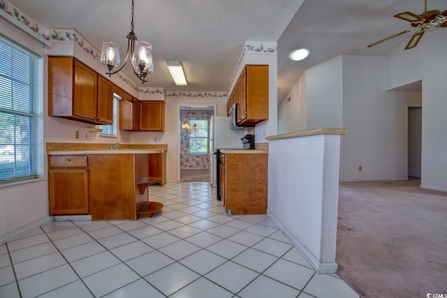 802 Mockingbird Ct, Murrells Inlet, SC 29576 - kitchen featuring light countertops, baseboards, brown cabinetry, and ceiling fan with notable chandelier