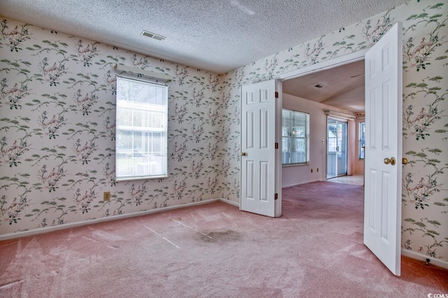 802 Mockingbird Ct, Murrells Inlet, SC 29576 - spare room with a textured ceiling, visible vents, light carpet, and wallpapered walls