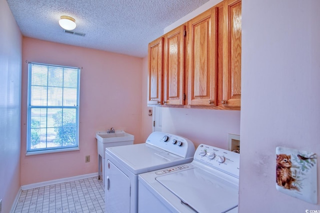 802 Mockingbird Ct, Murrells Inlet, SC 29576 - laundry area featuring visible vents, washer and dryer, baseboards, a textured ceiling, and cabinet space