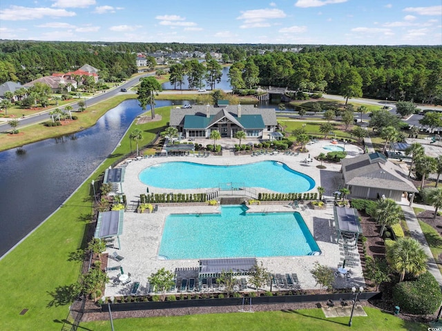 aerial view with a water view and a wooded view