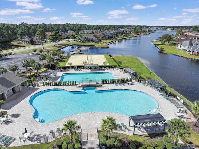 community pool featuring a patio, a water view, and a residential view