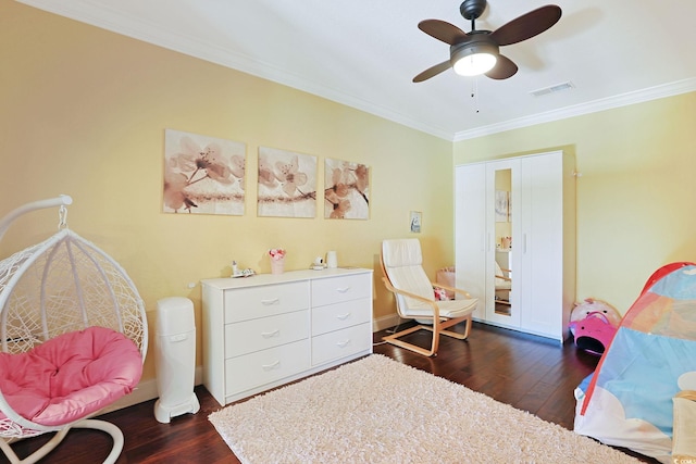bedroom with ceiling fan, visible vents, crown molding, baseboards, and dark wood-type flooring
