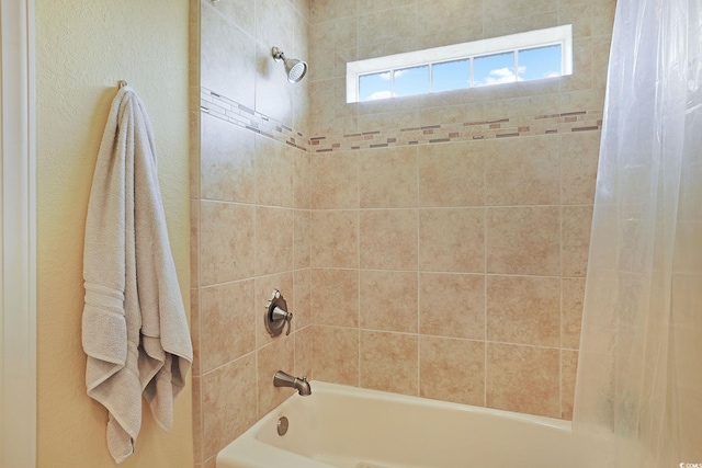 bathroom with shower / bath combination with curtain