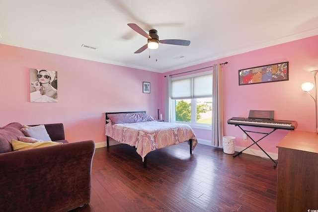 bedroom with crown molding, ceiling fan, hardwood / wood-style floors, baseboards, and visible vents