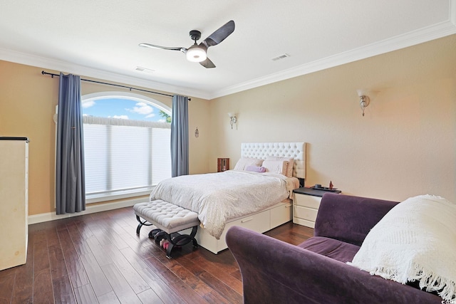 bedroom with ceiling fan, visible vents, crown molding, baseboards, and hardwood / wood-style floors