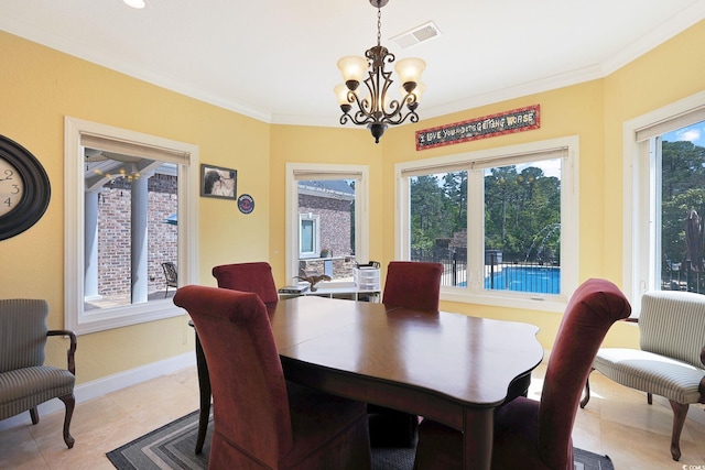 dining area with crown molding, a chandelier, baseboards, and visible vents
