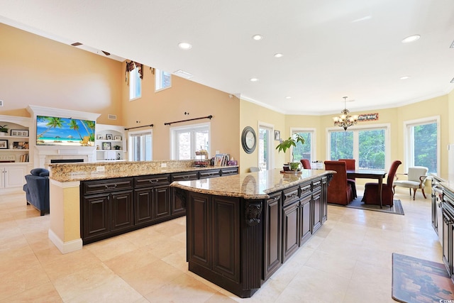 kitchen with crown molding, recessed lighting, an inviting chandelier, and a center island
