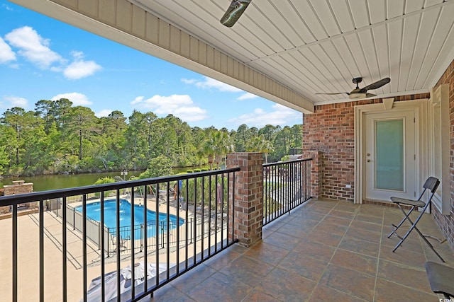 balcony with a ceiling fan and a water view
