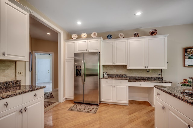 kitchen with backsplash, stainless steel refrigerator with ice dispenser, and light wood-type flooring