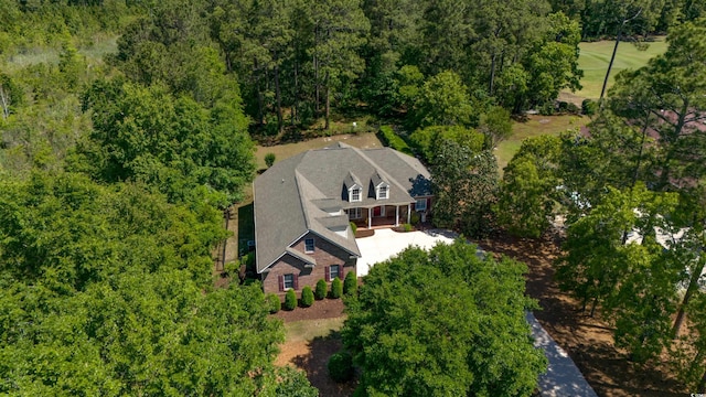 birds eye view of property featuring a view of trees
