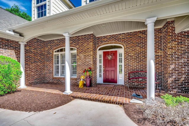 property entrance featuring brick siding