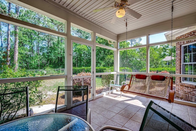 sunroom / solarium with a ceiling fan