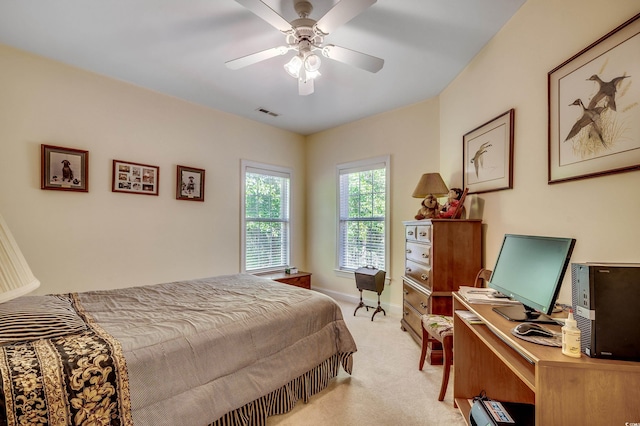bedroom featuring light colored carpet, a ceiling fan, and baseboards
