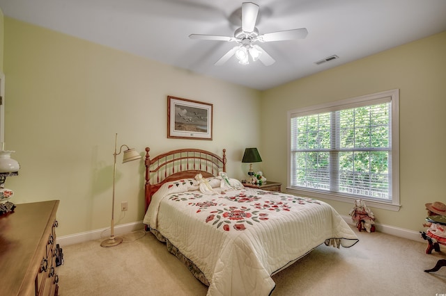 bedroom featuring baseboards, ceiling fan, light colored carpet, and visible vents