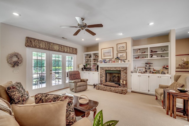 living room featuring ceiling fan, light carpet, a brick fireplace, french doors, and recessed lighting