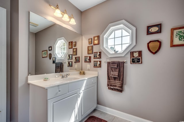 bathroom featuring vanity, baseboards, and tile patterned flooring