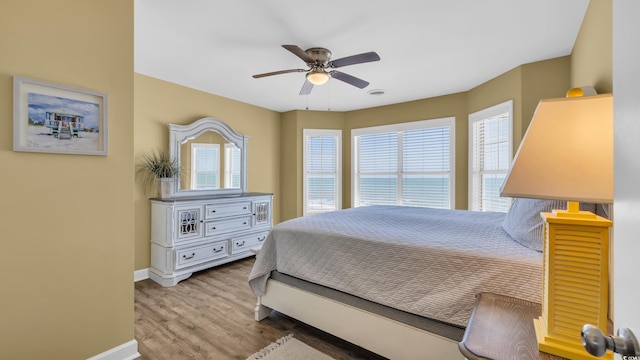 324 S Waccamaw Dr, Garden City Beach, SC 29576 - bedroom featuring baseboards, ceiling fan, visible vents, and wood finished floors