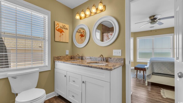 324 S Waccamaw Dr, Garden City Beach, SC 29576 - ensuite bathroom featuring baseboards, a sink, and wood finished floors