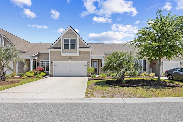 craftsman-style home with an attached garage and driveway