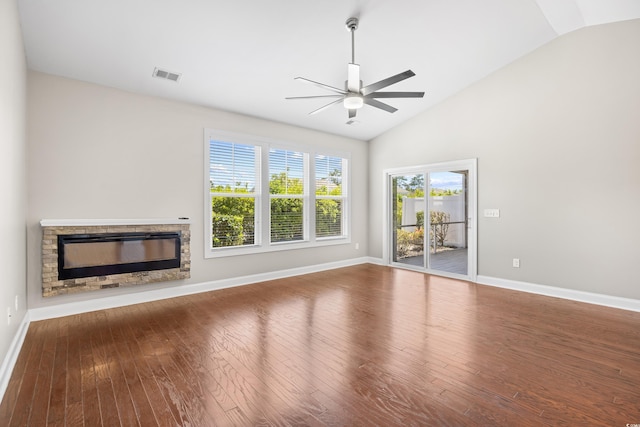 unfurnished living room featuring a stone fireplace, a ceiling fan, baseboards, vaulted ceiling, and visible vents