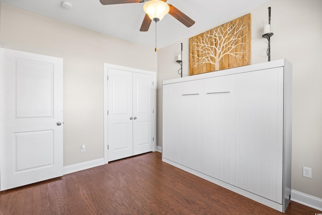 unfurnished bedroom featuring baseboards, ceiling fan, and wood finished floors