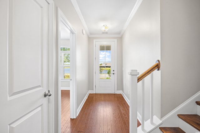 doorway to outside with crown molding, baseboards, and hardwood / wood-style floors