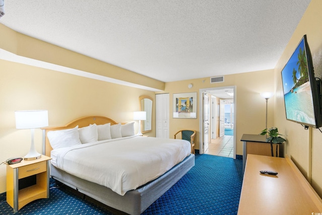 tiled bedroom with carpet flooring and a textured ceiling