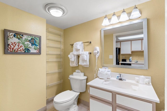 bathroom featuring toilet, vanity, and tile patterned floors
