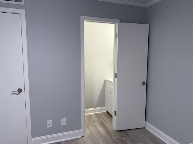 4350 Intercoastal Dr Unit 2302, Little River, SC 29566 - unfurnished bedroom featuring wood finished floors, baseboards, and crown molding