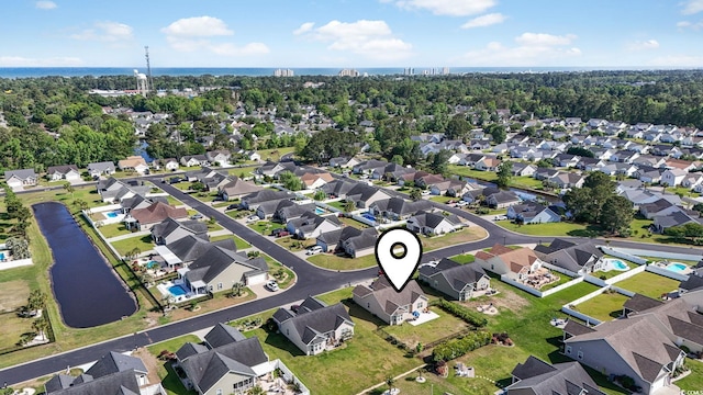 drone / aerial view with a water view and a residential view