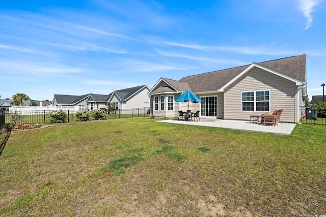 back of house with a yard, a patio, and a fenced backyard