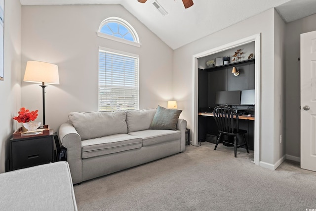 living room with visible vents, lofted ceiling, carpet flooring, baseboards, and a ceiling fan