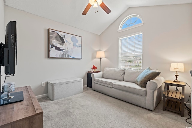 carpeted living room featuring vaulted ceiling, baseboards, and a ceiling fan